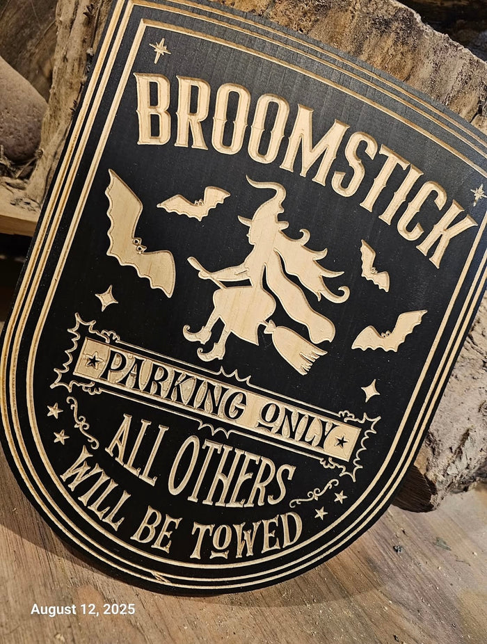 Broomstick Parking sign — carved lettering, border detail and a playful design built in the shop.