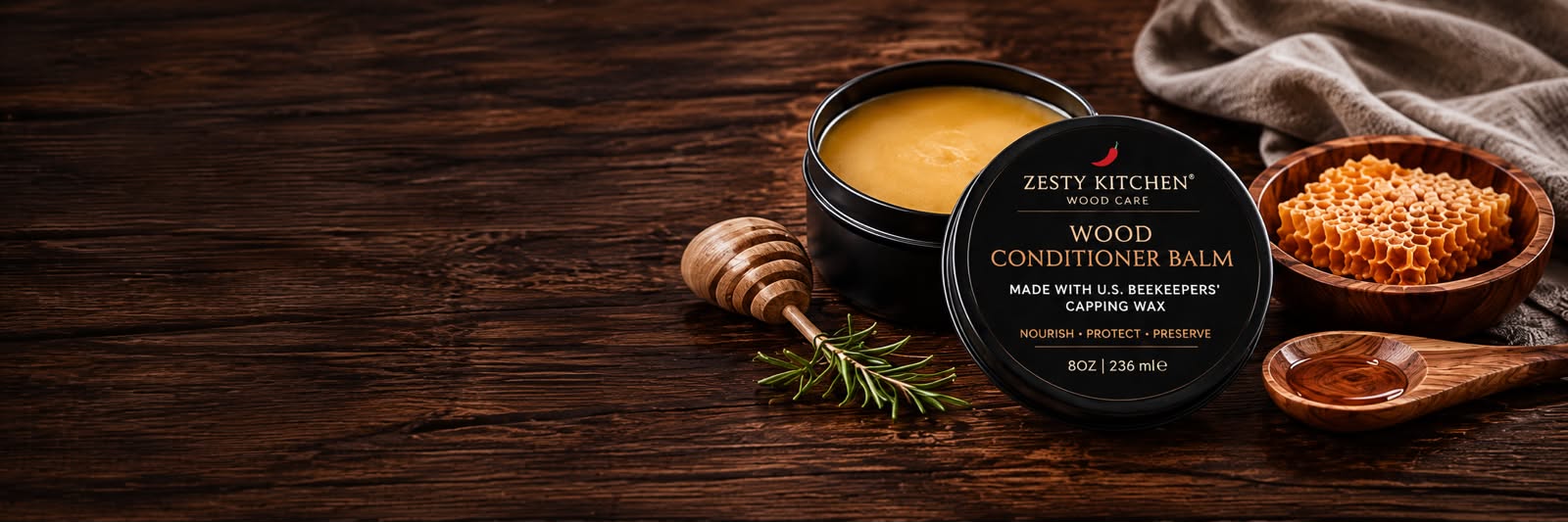 Zesty Kitchen wood conditioner balm on a wooden surface with honeycomb and honey dipper.